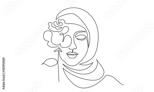 Young happy woman in hijab with flowers on her face