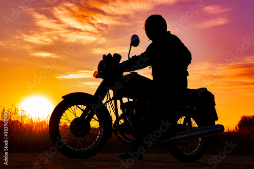 silhouette of a motorcyclist on a motorcycle, at sunset