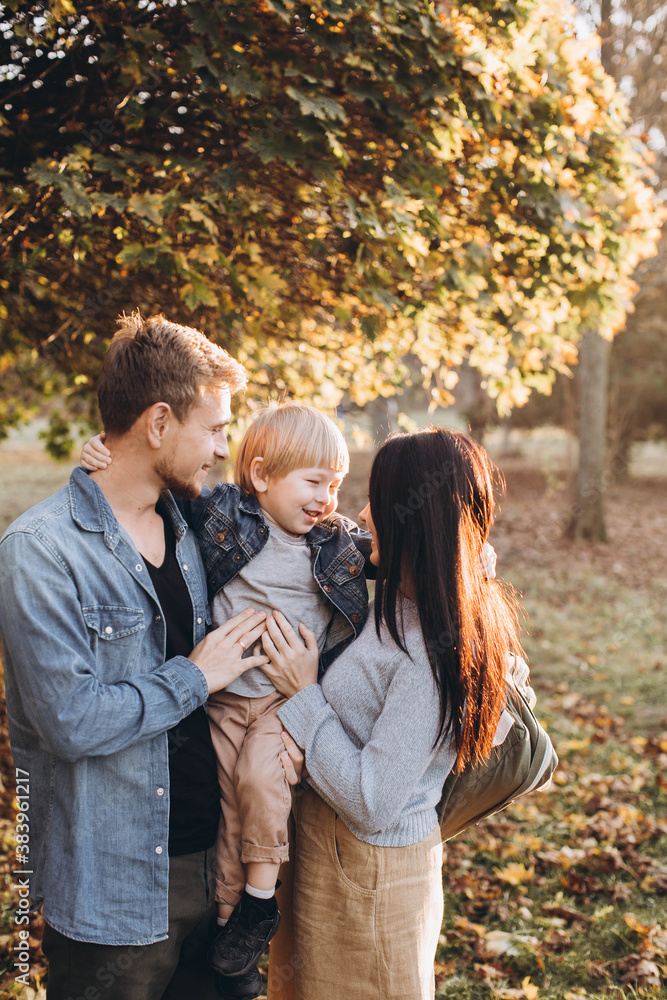 Fototapeta premium Family playing in autumn park having fun.