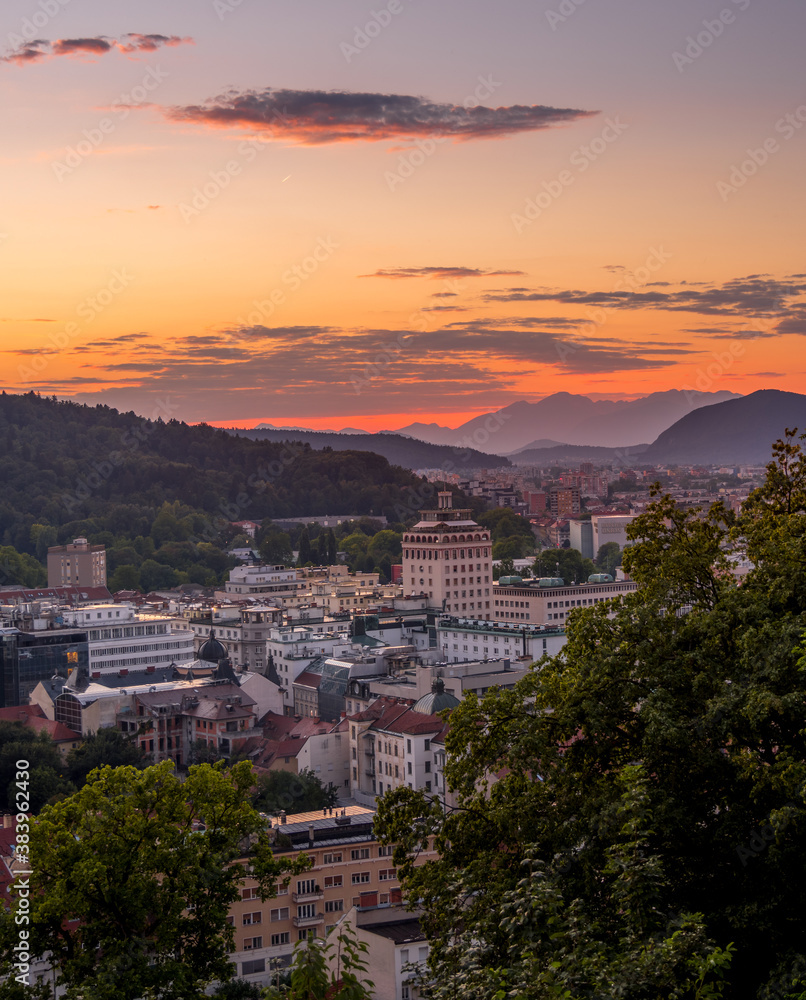 Ljubjana city view form castle hill during sunset with mountains in the background