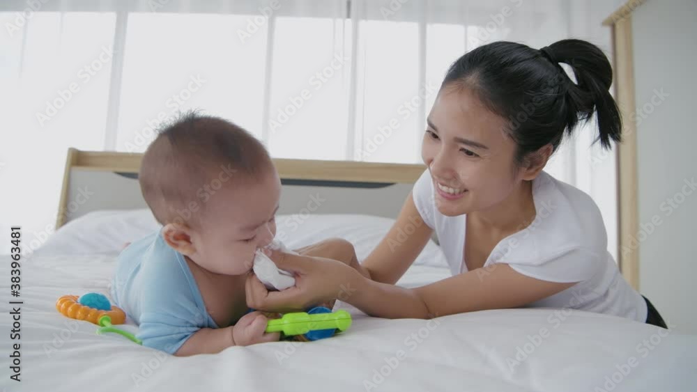 Family concept. Mother is wiping the snot on the baby. 4k Resolution.