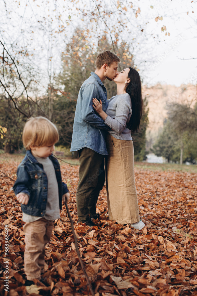 happy family mother father and baby on autumn walk in the park