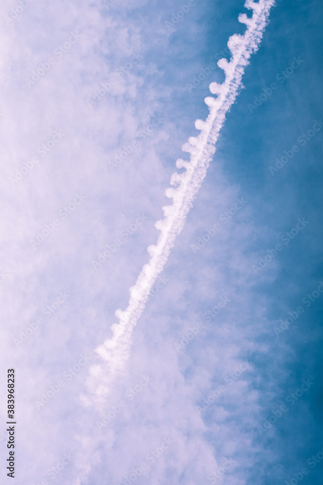 Trace of an airplane over cloudy blue sky Trace of an airplane over cloudy blue sky