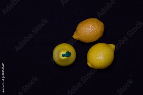 Photos of toy fruits on a dark background. Plastic toy