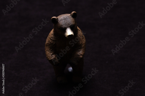 Toy brown bear on a dark background.