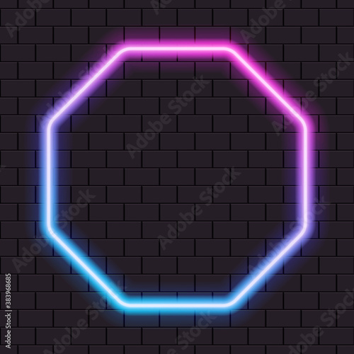 Bright neon octagon frame for banner or sign isolated on a dark brick wall.