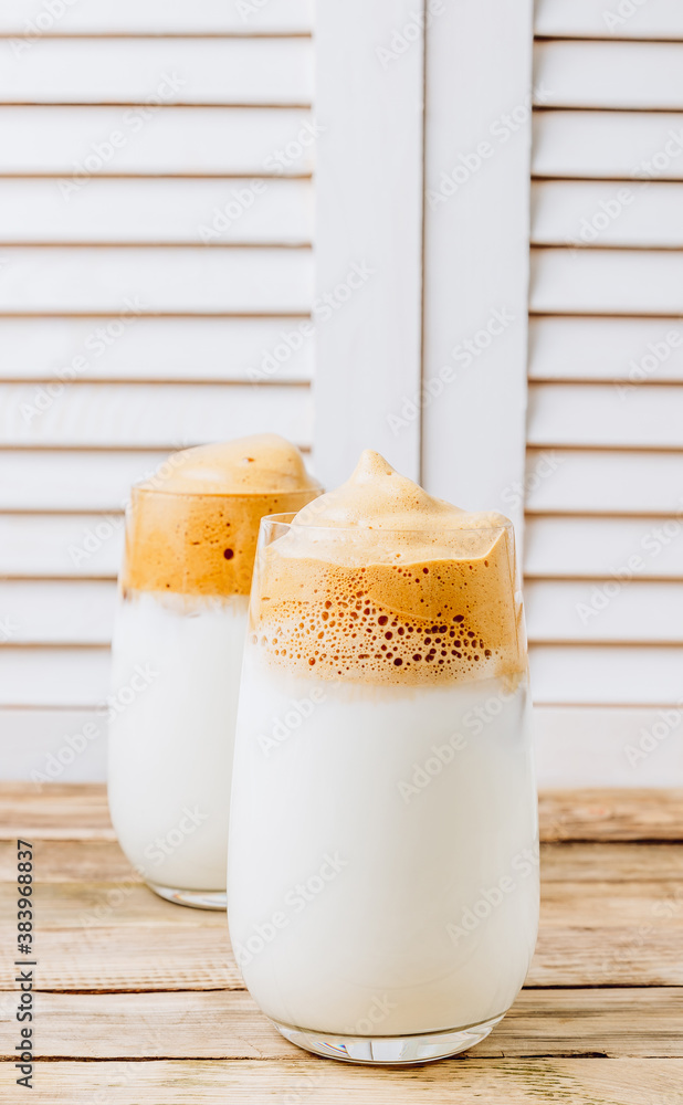 Iced frothy Dalgona Coffee, a trendy fluffy creamy whipped coffee. Korean drink latte espresso with coffee foam. made of instant coffee, sugar, hot water and milk. Iced frothy Dalgona Coffee, a trendy fluffy creamy whipped coffee. Korean drink latte espresso with coffee foam. made of instant coffee, sugar, hot water and milk.