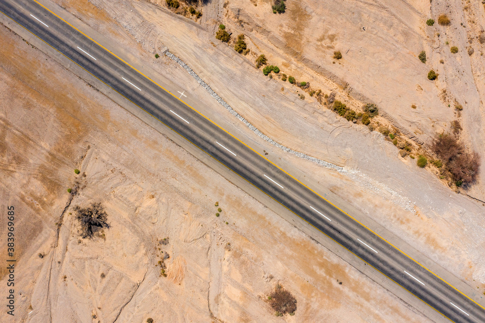 Φωτογραφία Desert road, Aerial image of a new two lane road surrounded by dry desert landsc