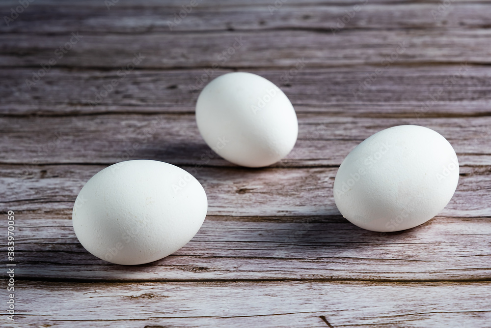 Raw chicken eggs set on wooden table Raw chicken eggs set on wooden table
