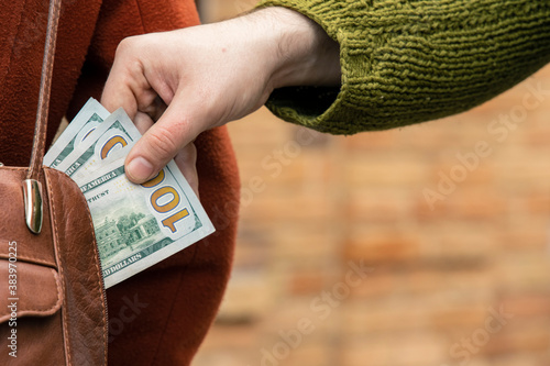 Bild auf Leinwand crime pickpocketing on the street money dollars cash money.