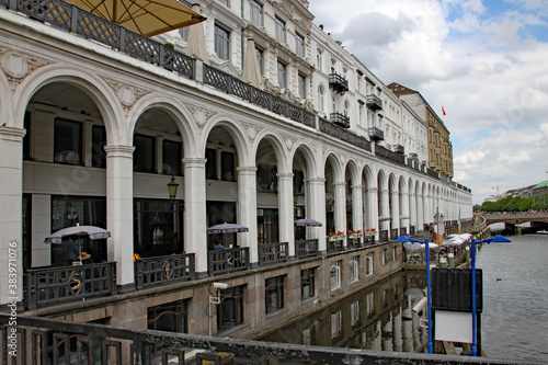 The white arches of the Alsterarkaden buildings alongside the Alster river in downtown Hamburg