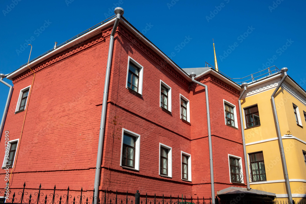Exterior facade of the red house. Urban vintage background.Bright facades
