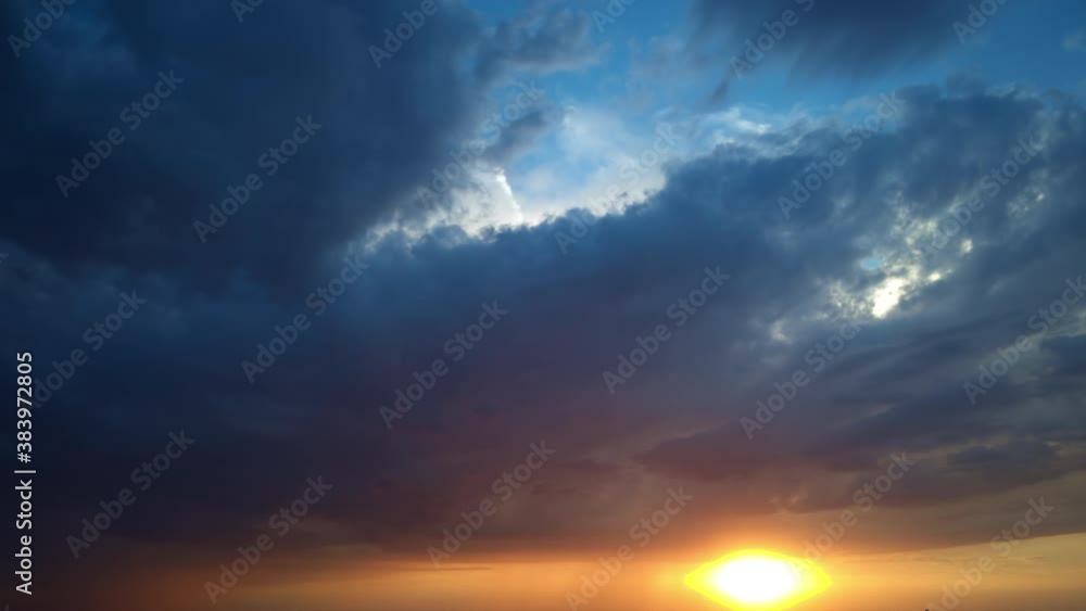 Dark grey storm clouds. Sky orange and black cloud. Dramatic sky. Lighting in dark stormy cloudy. Nature time lapse storm clouds at sunset time. Timelapse. Dark grey storm clouds. Sky orange and black cloud. Dramatic sky. Lighting in dark stormy cloudy. Nature time lapse storm clouds at sunset time. Timelapse.