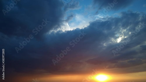 Dark grey storm clouds. Sky orange and black cloud. Dramatic sky. Lighting in dark stormy cloudy. Nature time lapse storm clouds at sunset time. Timelapse.
