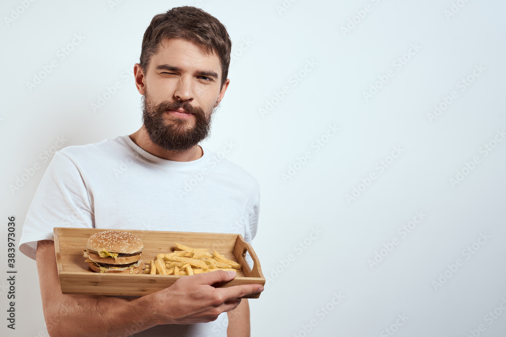 man with wooden tray fries and hamburger fast food calories model white t-shirt man with wooden tray fries and hamburger fast food calories model white t-shirt
