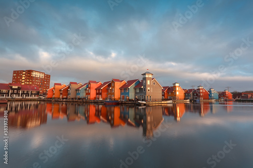 colorful buildings on water in morning sunlight photo