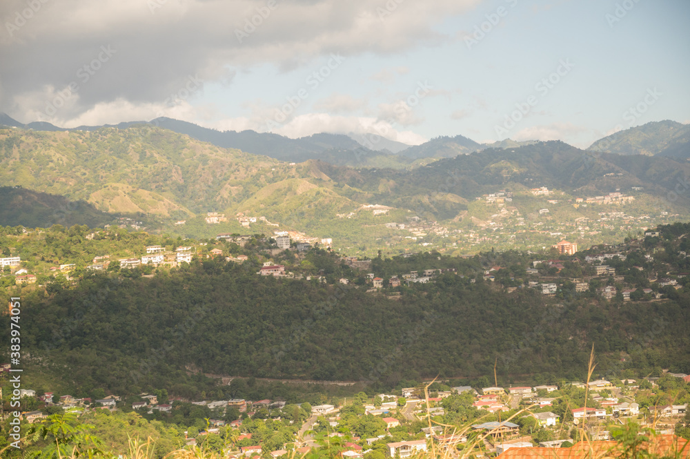 wide angle shot of a town in a valley with mountains in the distance on an island on a warm spring afternoon