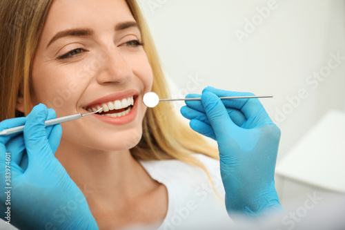Doctor examining patient s teeth in clinic  closeup. Cosmetic dentistry
