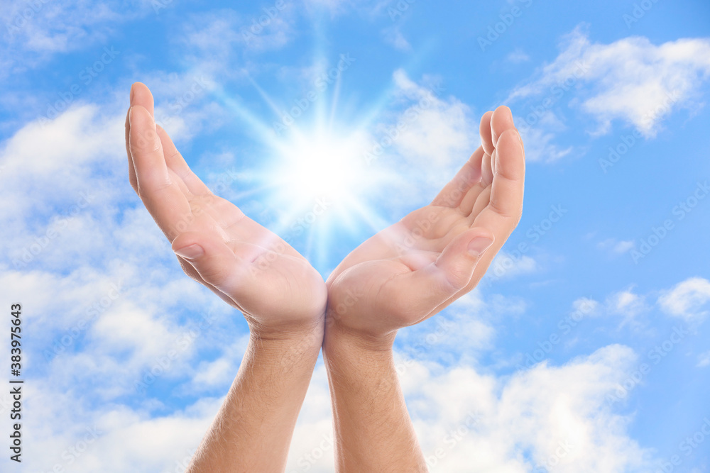 Bright light in hands, closeup. Solar energy concept Bright light in hands, closeup. Solar energy concept