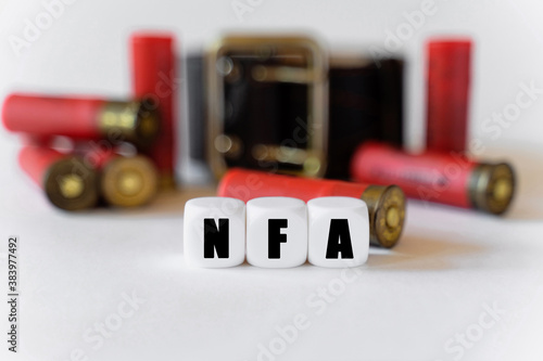 Against the background of cartridges and a military belt, cubes with the inscription - NFA photo