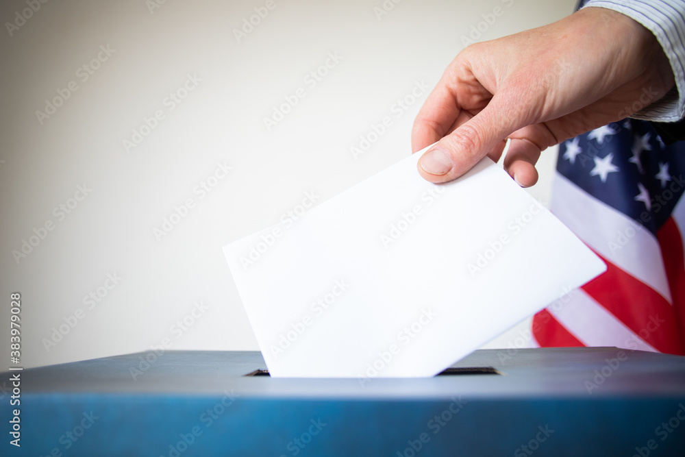 hand putting vote in ballot USA elections hand putting vote in ballot USA elections