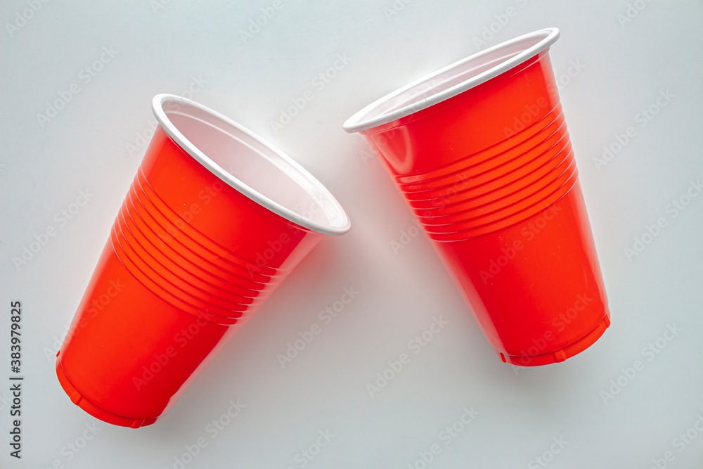 Close up to single use red plastic glass on a white background. Concept: Ban single use plastic Close up to single use red plastic glass on a white background. Concept: Ban single use plastic