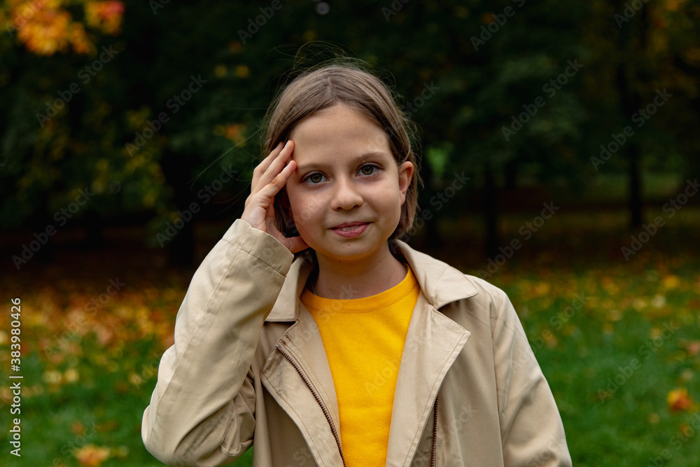 adorable little girl with autumn leaves in the park