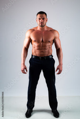 Muscular guy with sexy torso. Full length.