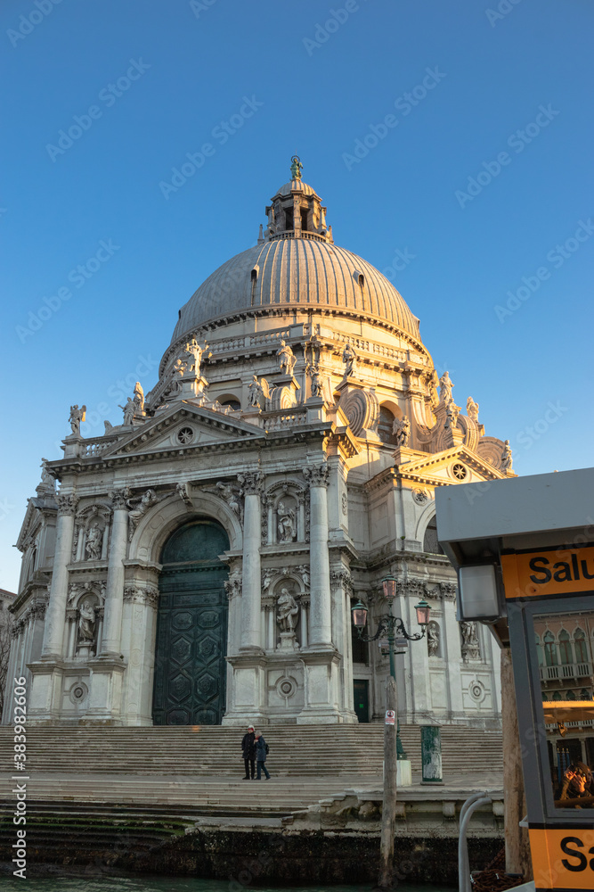 Fototapeta premium The setting afternoon casts Basilica di Santa Maria della Salute into half shadow 