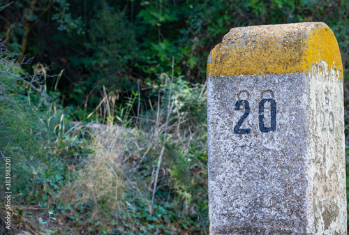 Old milestones exposed on the Bailen-Motril road (N-323) as it passes through La Cerradura de Pegalajar (Jaen-Spain) photo