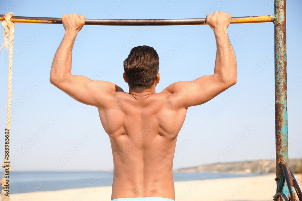 Man with slim body doing pull-ups