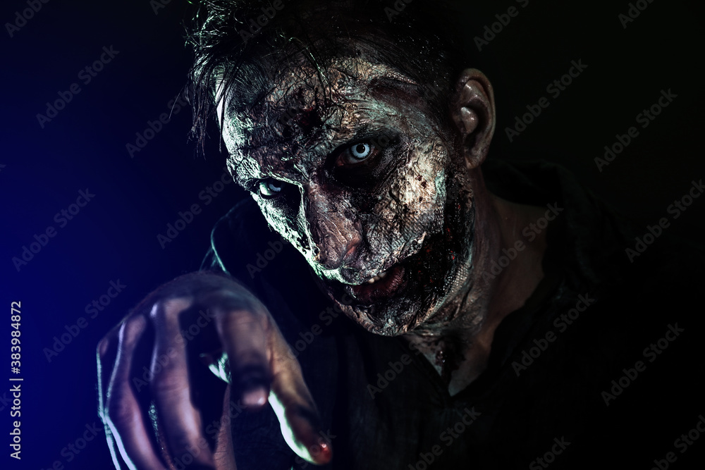Scary zombie on dark background. Halloween monster Scary zombie on dark background. Halloween monster