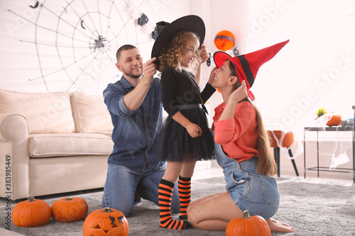 Happy family getting ready for Halloween party at home