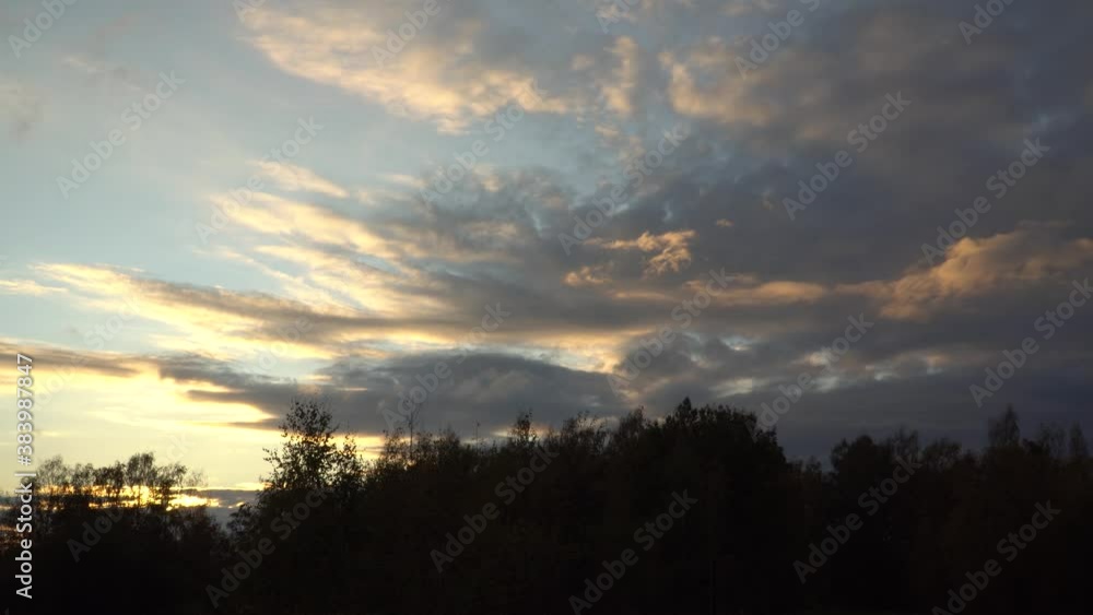 Sunset sky with clouds and bright yellow lights of sundown in heaven. Peaceful evening scene in nature before the dusk hour comes. Sunset sky with clouds and bright yellow lights of sundown in heaven. Peaceful evening scene in nature before the dusk hour comes.