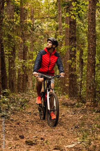Cyclist in the jungle. Sportsman in the jungle. Alternative sports and outdoor concept.