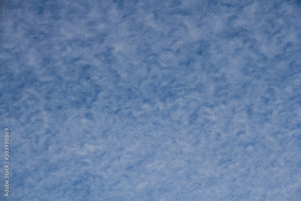 Blue sky with cloud curls 