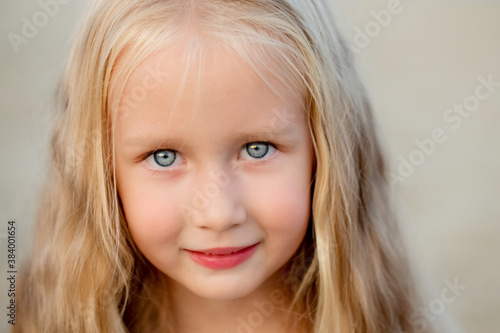 Photos Portrait of a beautiful little blue-eyed blonde girl