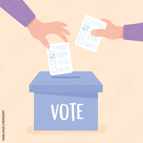 election day, hands pushing paper ballot on cardboard box