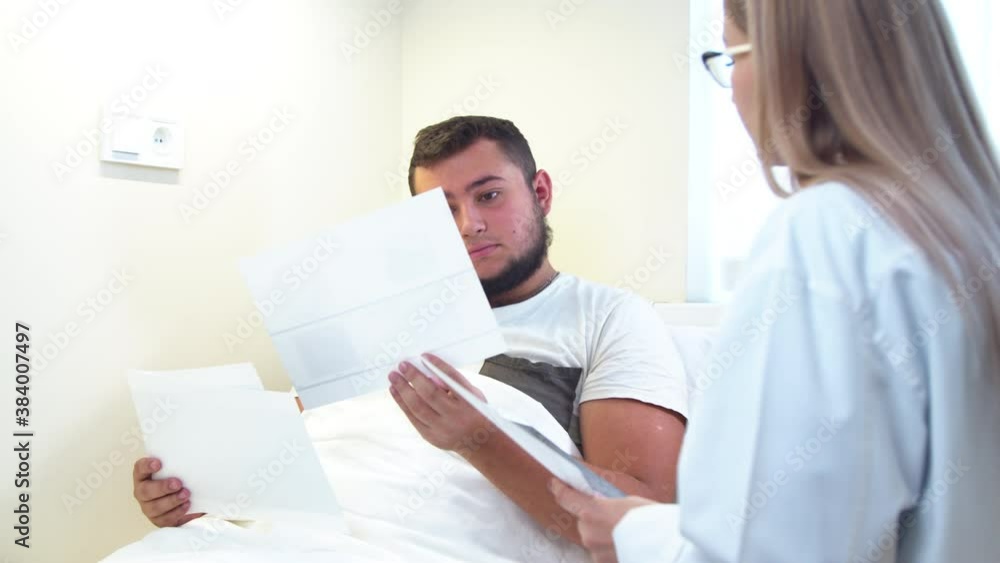 Dentist showing X ray scans to patient in clinic Dentist showing X ray scans to patient in clinic
