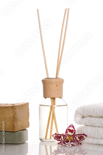 aroma therapy objects. bottle of esential oil, candle, towels, soap photo