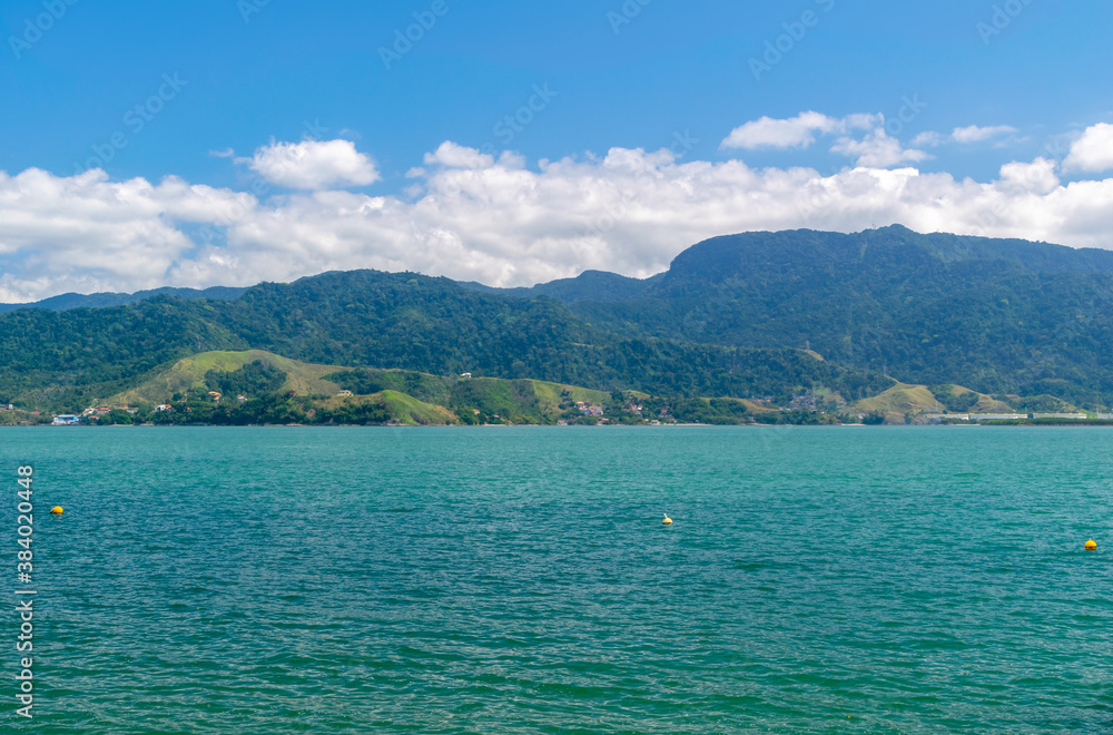 Quiet view of the sea, on the coast of Ilhabela. In the background, part of the city of São Sebastião. Brazil