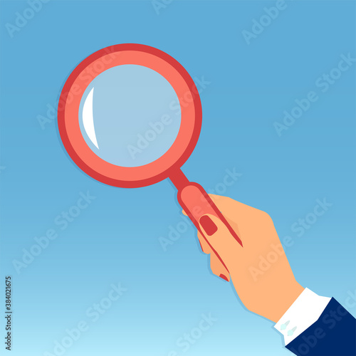 Vector of a female hand holding a magnifying glass