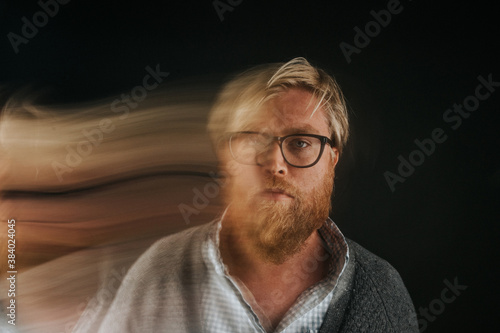 Portrait of man with blurred motion standing indoors