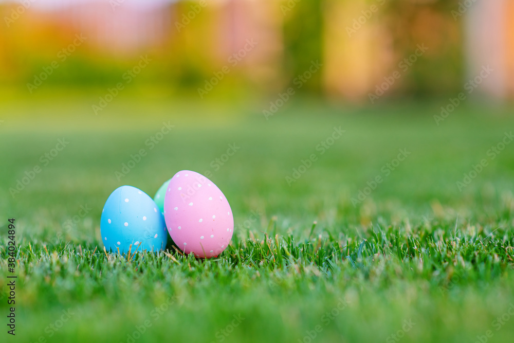 Painted Easter eggs lie on the green grass. Easter still life