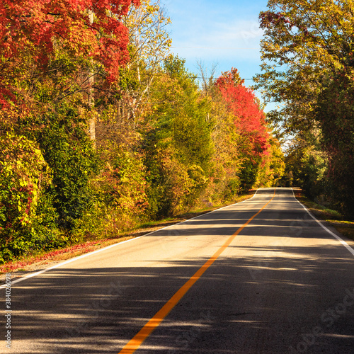 Country road at fall - colorful trees - in Quebec, Canada