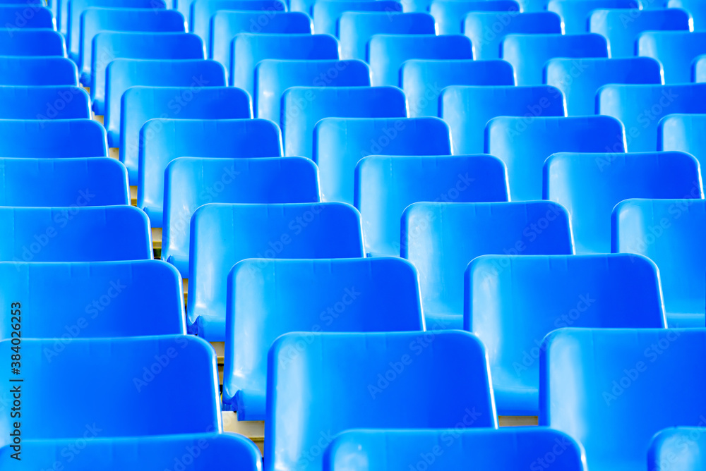Fototapeta premium geometric photo of a set of blue seats on the outdoor grandstand of a sports court