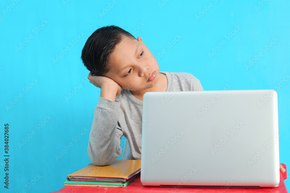 Tired little boy feel bored and sleepy while studying Tired little boy feel bored and sleepy while studying