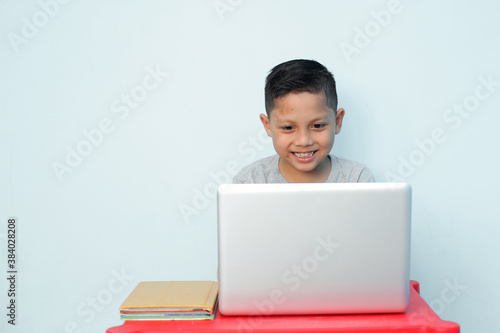 portrait of school boy with happy expression while studying. excited feeling © Gatot