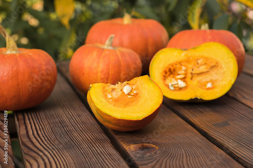 A large number of ripe fresh pumpkins on a wooden table.
