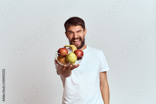 man with fresh fruit in a glass cup gesturing with hands vitamins health energy model bushy beard mustache